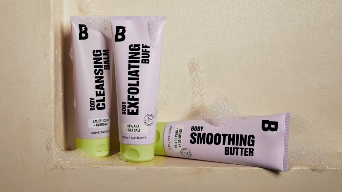 Three body care products lined up in the shower