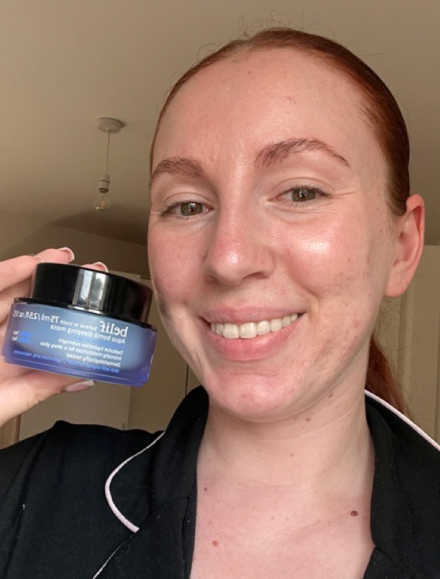 Someone holding a Belif skincare product and smiling