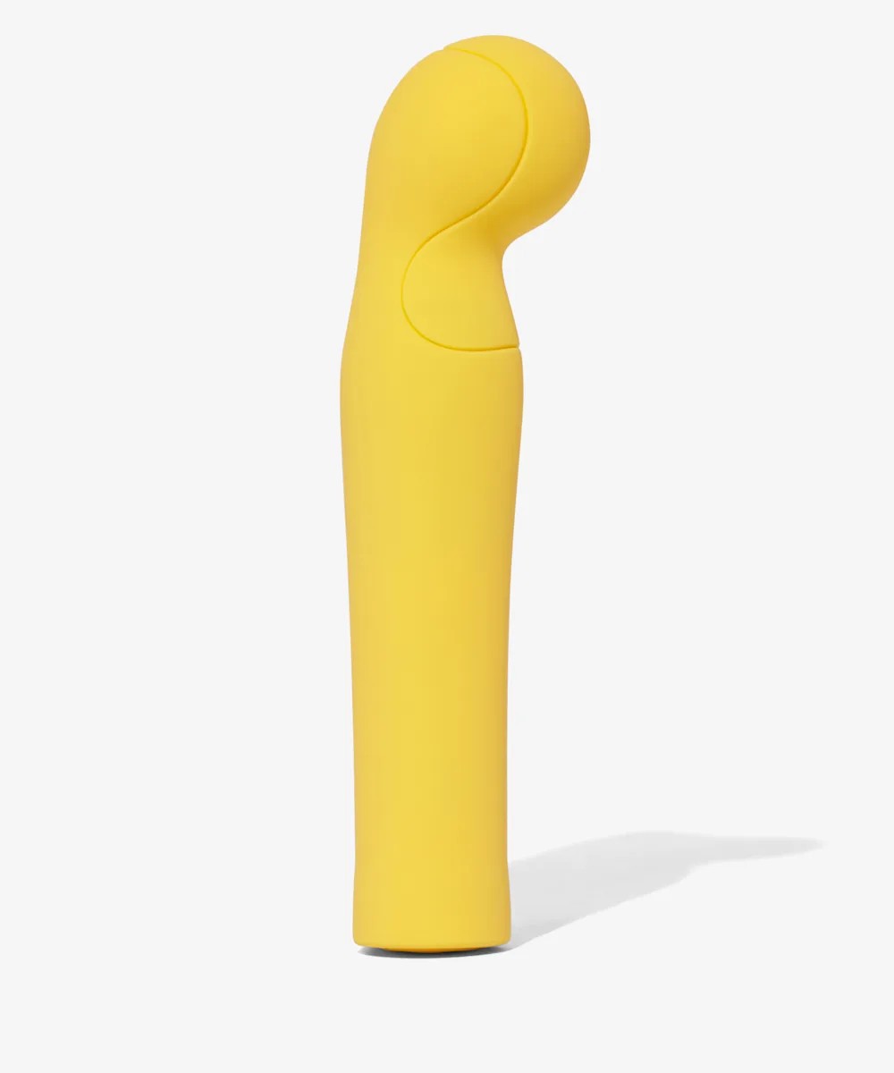 A yellow vibrator standing up on a white background