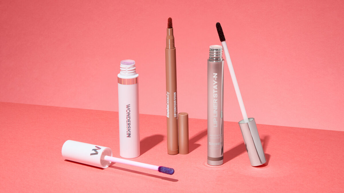 Three lip stain products laid out next to one another, each one with the lid removed.