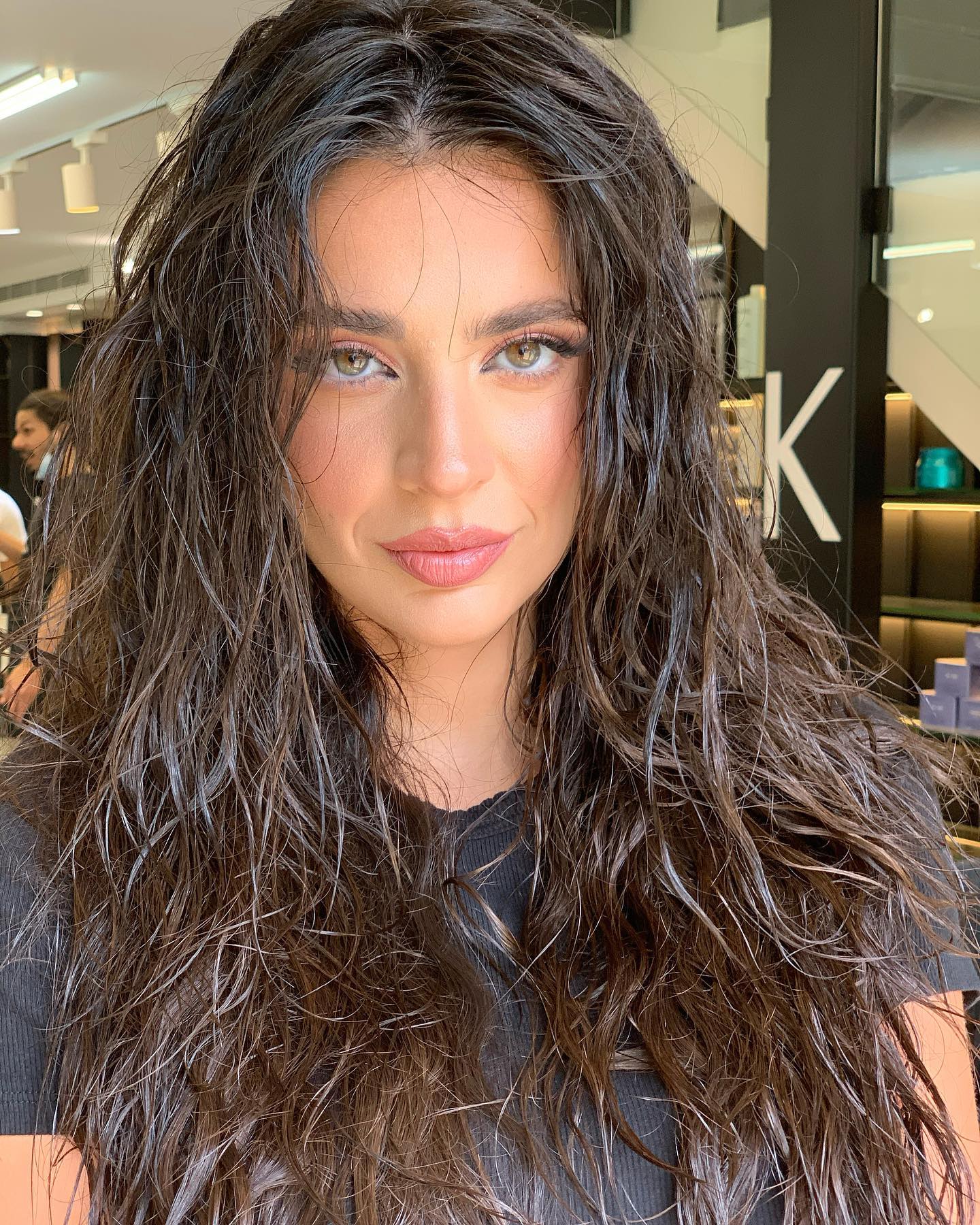 A woman with long wet look waves
